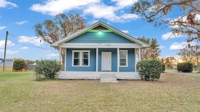 bungalow-style home featuring a front yard and a porch