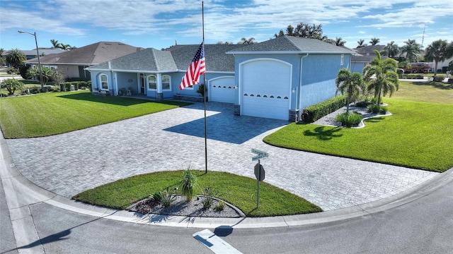 single story home with a garage and a front lawn