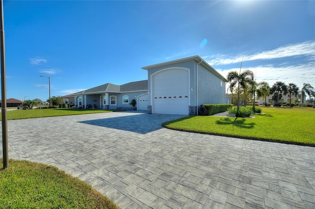 ranch-style home featuring a garage and a front lawn