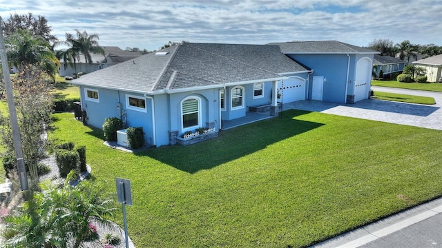 ranch-style home featuring a garage and a front lawn