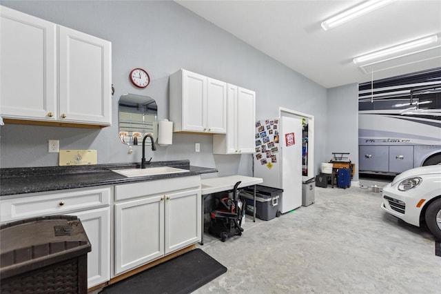 kitchen with sink, white cabinets, and white fridge