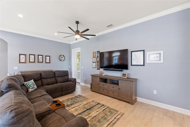 living room with crown molding, light hardwood / wood-style flooring, and ceiling fan