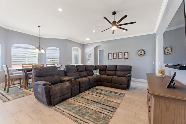 living room with light hardwood / wood-style floors, ornamental molding, and ceiling fan with notable chandelier