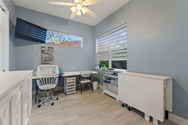 office space with ceiling fan and light hardwood / wood-style flooring