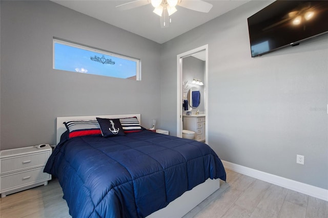 bedroom with ceiling fan, connected bathroom, and light wood-type flooring