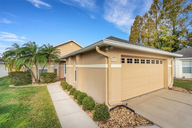 ranch-style home with a front yard and a garage