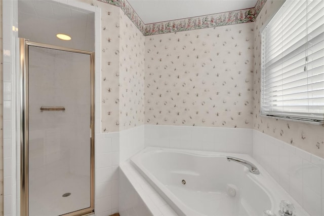 bathroom featuring a healthy amount of sunlight and separate shower and tub