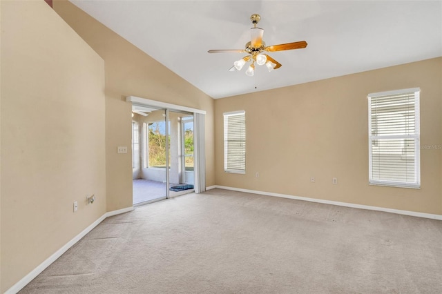 carpeted spare room with lofted ceiling and ceiling fan