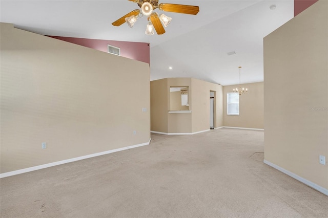 unfurnished living room featuring ceiling fan with notable chandelier, light colored carpet, and vaulted ceiling