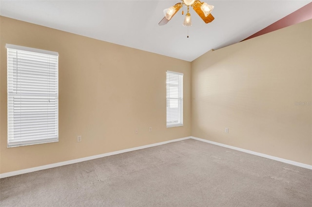 carpeted empty room with ceiling fan and vaulted ceiling