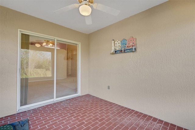 doorway to property featuring a patio and ceiling fan