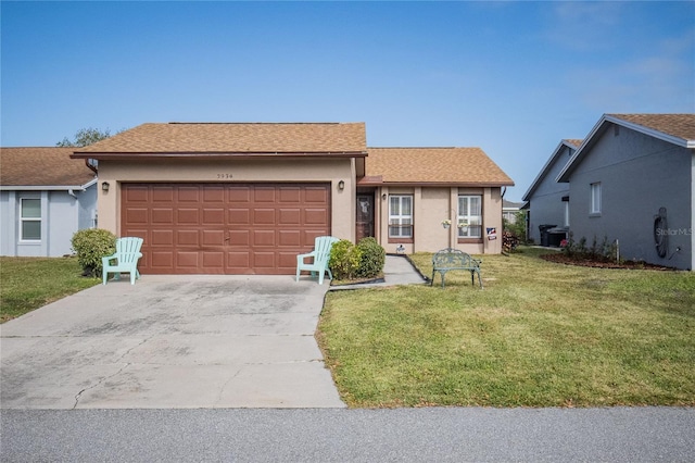 ranch-style home featuring a front lawn and a garage