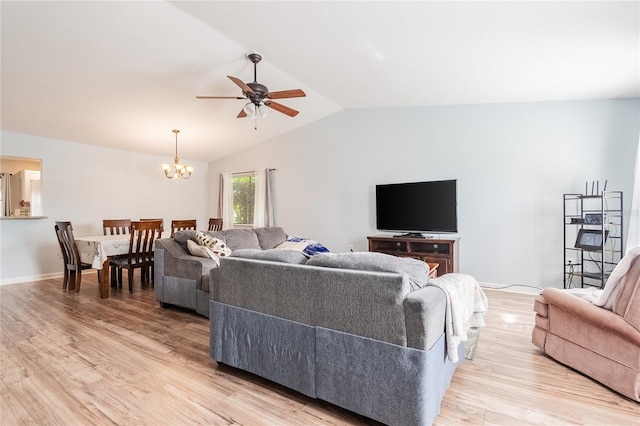 living room featuring ceiling fan with notable chandelier, light hardwood / wood-style flooring, and lofted ceiling