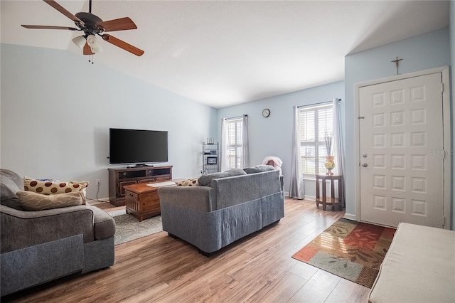 living room with vaulted ceiling, ceiling fan, and hardwood / wood-style floors