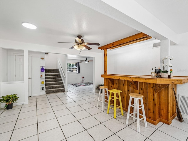 bar featuring ceiling fan and light tile patterned floors