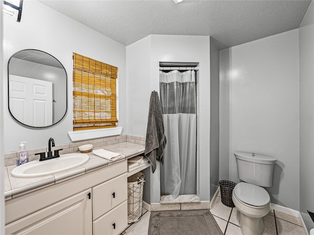 bathroom with toilet, tile patterned floors, a textured ceiling, a shower with curtain, and vanity