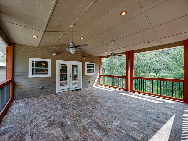 unfurnished sunroom with ceiling fan and french doors