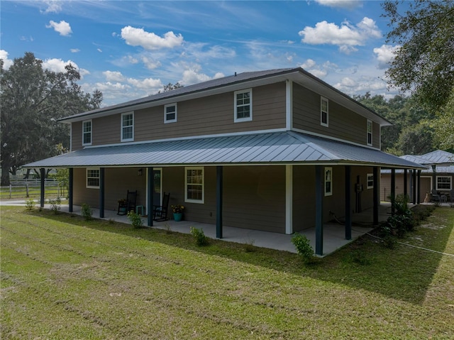 rear view of property with a patio area and a yard