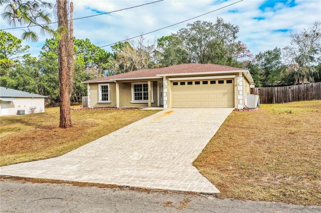 view of front of property featuring a front yard and a garage