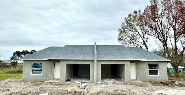 rear view of house with a garage