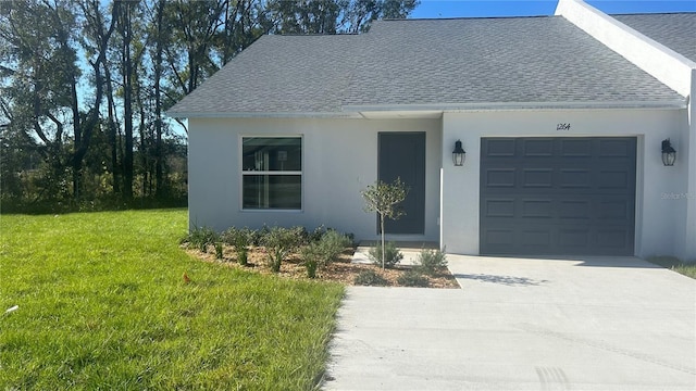 view of front of home with a front yard and a garage