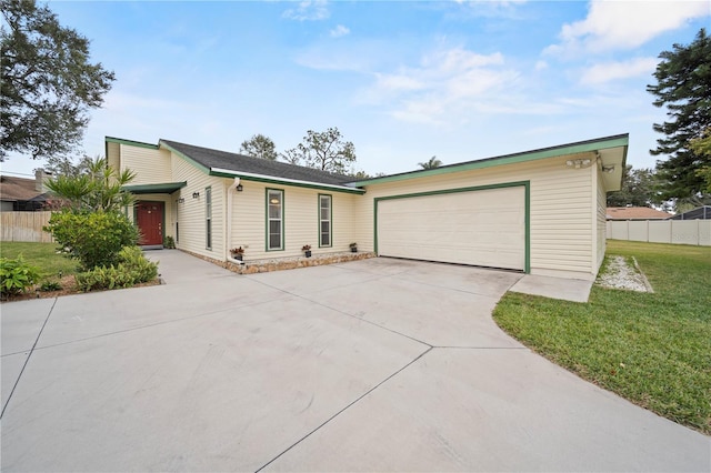 ranch-style house featuring a front lawn and a garage