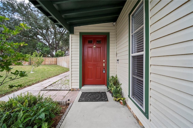 property entrance with a yard