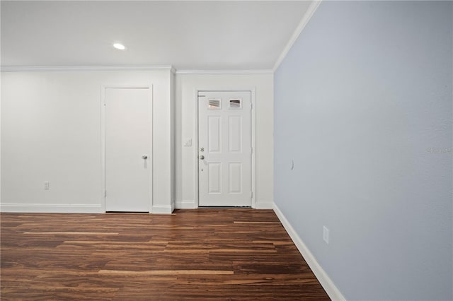 empty room featuring dark wood-type flooring and ornamental molding