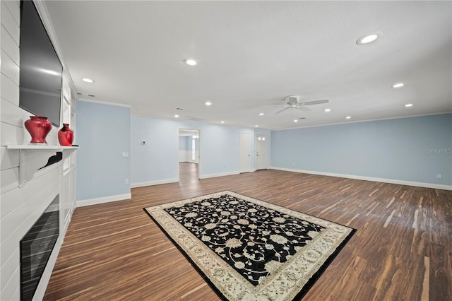 living room with ceiling fan, ornamental molding, and dark hardwood / wood-style floors