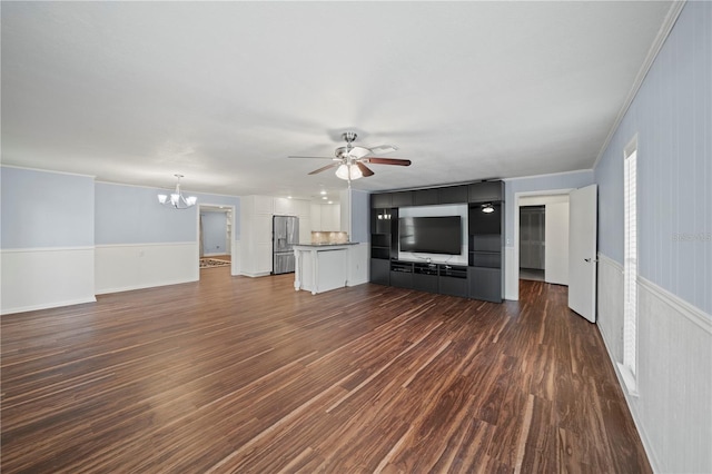 unfurnished living room featuring crown molding, dark hardwood / wood-style floors, and ceiling fan with notable chandelier