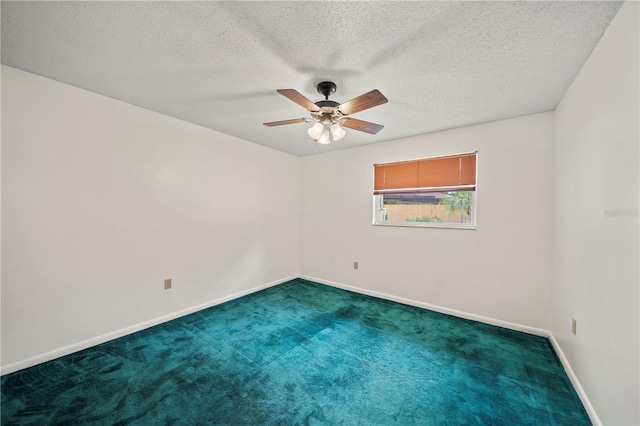 carpeted spare room featuring a textured ceiling and ceiling fan