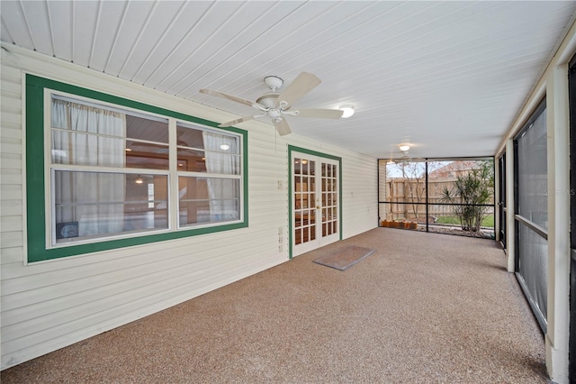 unfurnished sunroom featuring ceiling fan