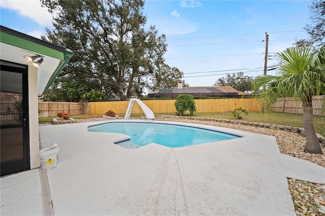 view of swimming pool with a patio area and a water slide