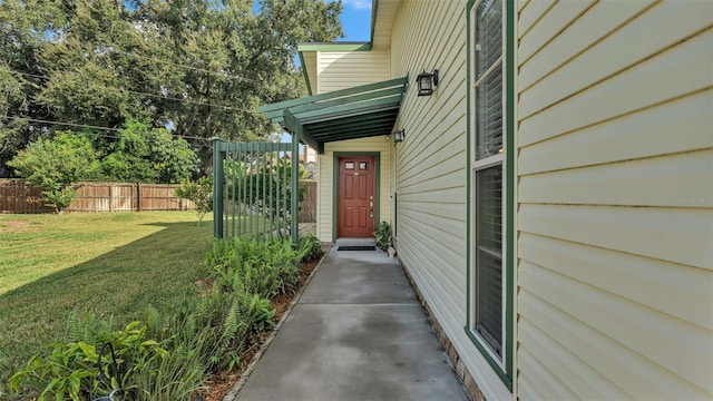 property entrance with a lawn