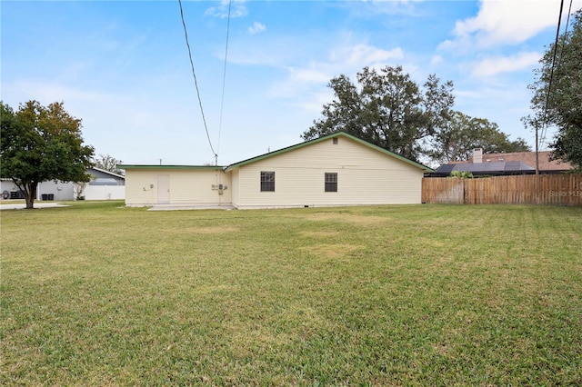 rear view of property with a patio area and a yard