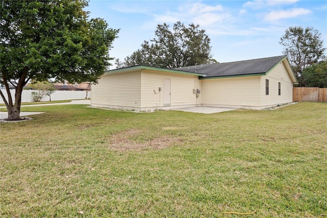 rear view of property with a patio area and a yard