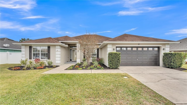 view of front of house featuring a front yard and a garage