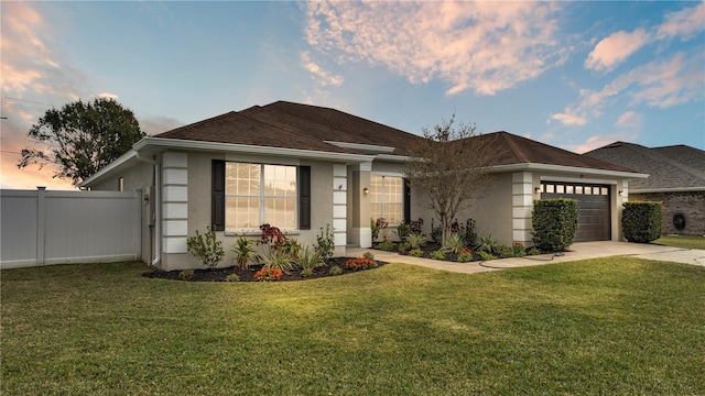 view of front of house with a garage and a lawn