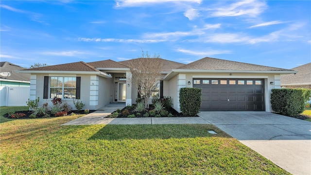 view of front of property featuring a garage and a front yard