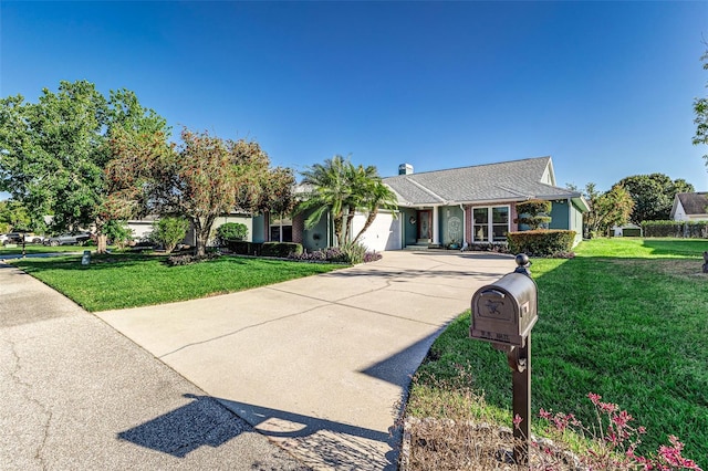 view of front of home with a garage, concrete driveway, and a front lawn