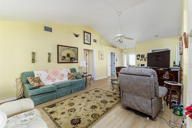 living area featuring a ceiling fan, baseboards, wood finished floors, visible vents, and high vaulted ceiling