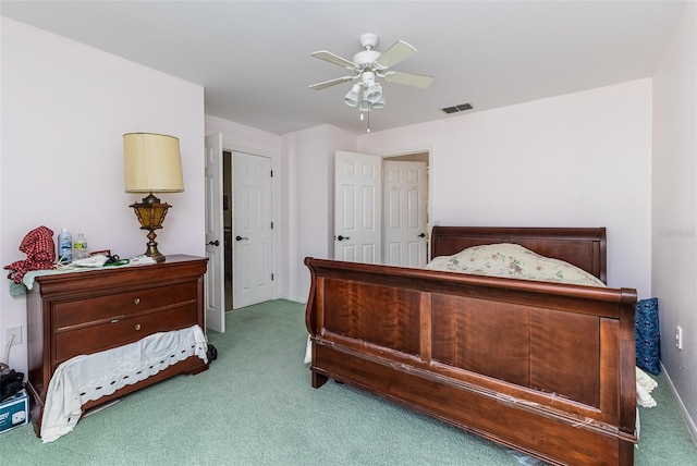 bedroom featuring visible vents, carpet, and a ceiling fan