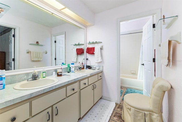 bathroom featuring double vanity, tub / shower combination, baseboards, and a sink