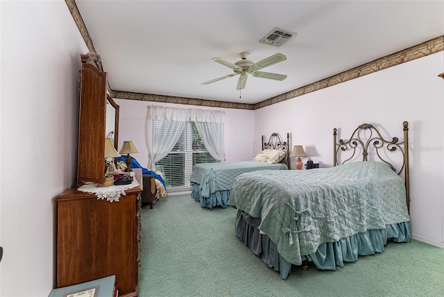 carpeted bedroom with visible vents and a ceiling fan