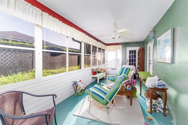 sunroom featuring a ceiling fan and a healthy amount of sunlight