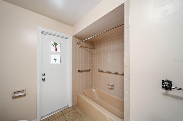 bathroom with tiled shower / bath combo and tile patterned flooring