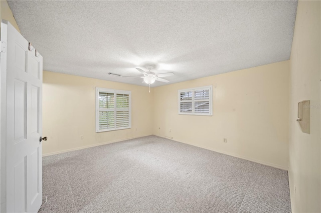 spare room featuring ceiling fan, a textured ceiling, and carpet flooring