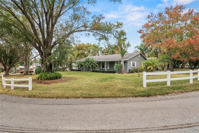 ranch-style home featuring a front yard