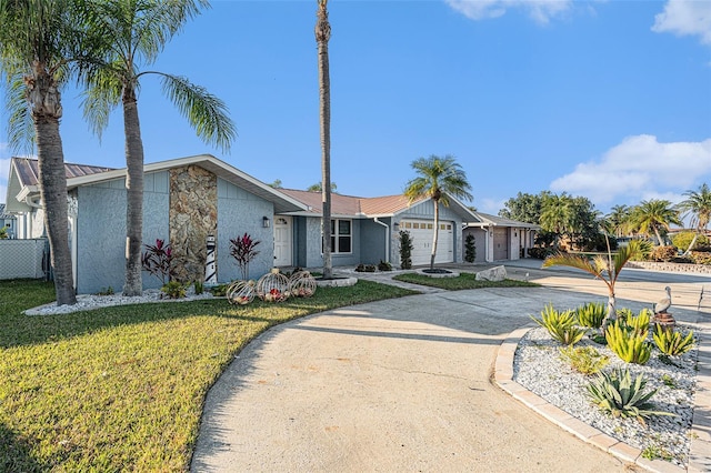 ranch-style house with a garage and a front lawn