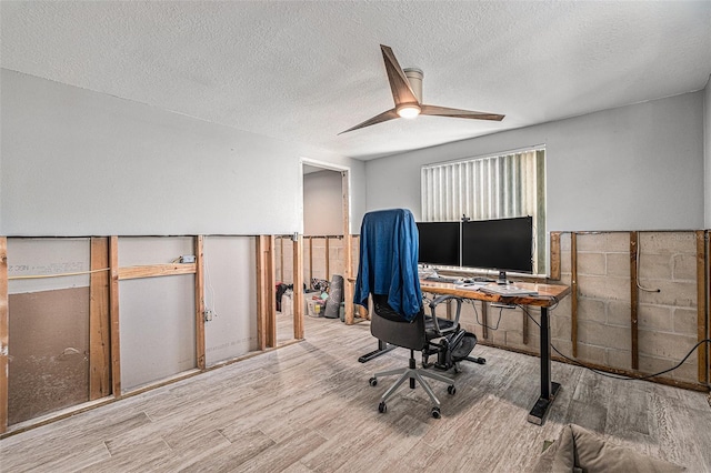 home office featuring ceiling fan, a textured ceiling, and light hardwood / wood-style floors